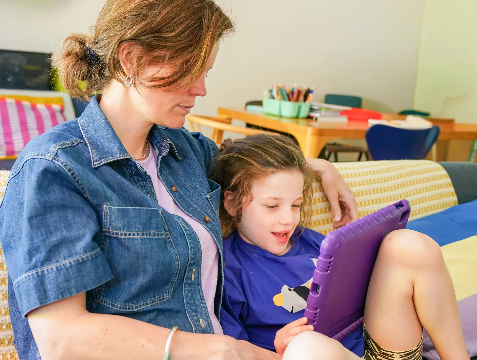 A parent and child enjoying calm screen time together