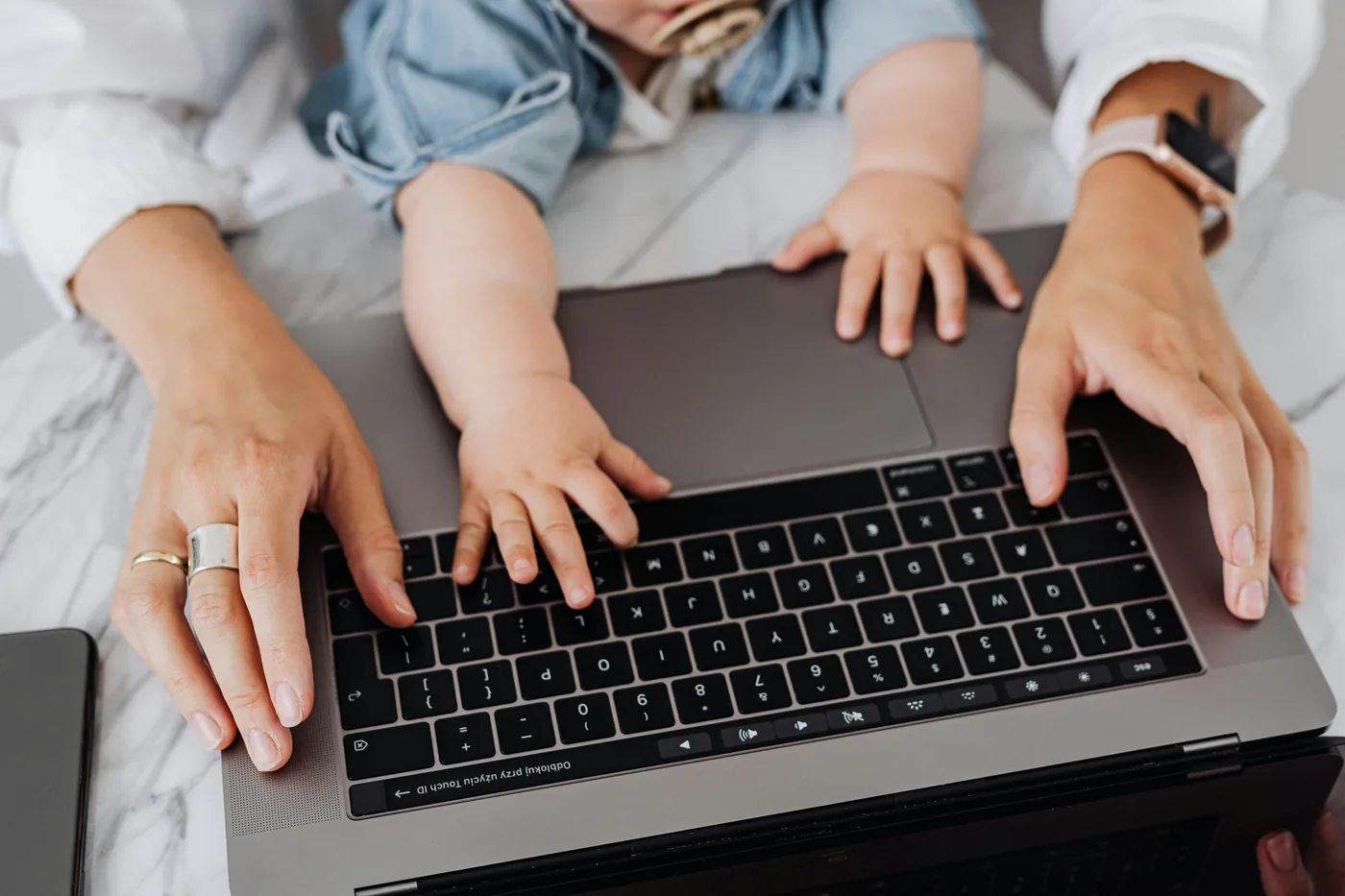 Baby hands on laptop keyboard